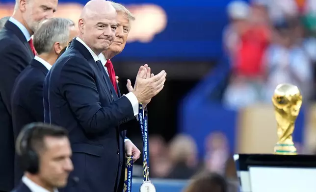 U.S. President Donald J. Trump and FIFA President Gianni Infantino applaud to welcome the players during the presentation ceremony after the World Cup final soccer match between Spain and Argentina in East Rutherford, N.J., near New York, Sunday, July 19, 2026. (AP Photo/Frank Franklin II)