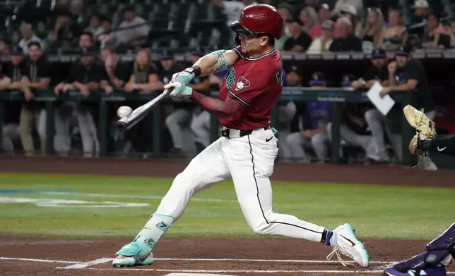 Arizona Diamondbacks' Corbin Carroll hits a solo home run against the Colorado Rockies in the first inning of a baseball game, Tuesday, Aug. 11, 2026, in Phoenix. (AP Photo/Rick Scuteri)