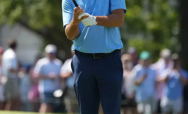 Scottie Scheffler prepares to hit on the first fairway in the final round of the BMW Championship golf tournament, Sunday, Aug. 23, 2026, in St. Louis. (AP Photo/Jeff Roberson)