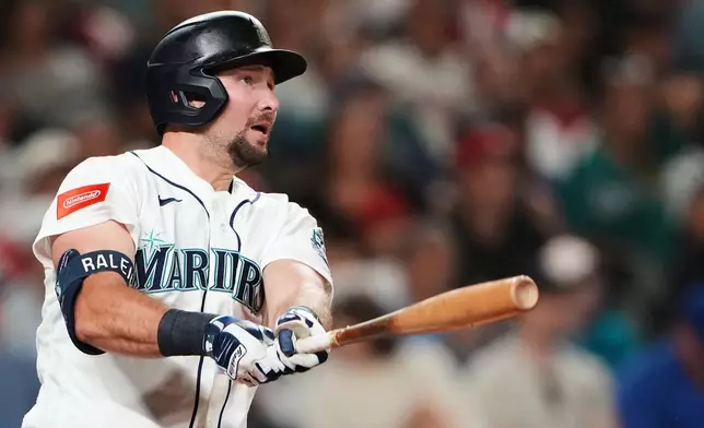 Seattle Mariners' Cal Raleigh follows through on a solo home run against the Philadelphia Phillies during the seventh inning of a baseball game, Monday, Aug. 24, 2026, in Seattle. (AP Photo/Lindsey Wasson)