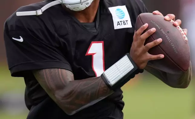 Atlanta Falcons quarterback Tua Tagovailoa (1) works out during an NFL training camp, Friday, Aug. 7, 2026, in Flowery Branch, Ga. (AP Photo/Mike Stewart)