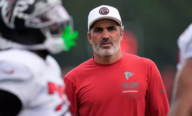 Atlanta Falcons head coach Kevin Stefanski watches the team work out during an NFL training camp, Friday, Aug. 7, 2026, in Flowery Branch, Ga. (AP Photo/Mike Stewart)