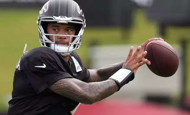 Atlanta Falcons quarterback Tua Tagovailoa (1) works out during an NFL training camp, Friday, Aug. 7, 2026, in Flowery Branch, Ga. (AP Photo/Mike Stewart)