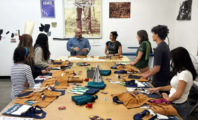 Levi’s employees teach students during a sewing workshop at a Levi's retail store in downtown San Francisco, Wednesday, July 22, 2026. (AP Photo/Terry Chea)