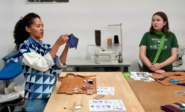 Levi’s employee Ella Fassler Clausen teaches during a sewing workshop at a Levi's retail store in downtown San Francisco, Wednesday, July 22, 2026. (AP Photo/Terry Chea)