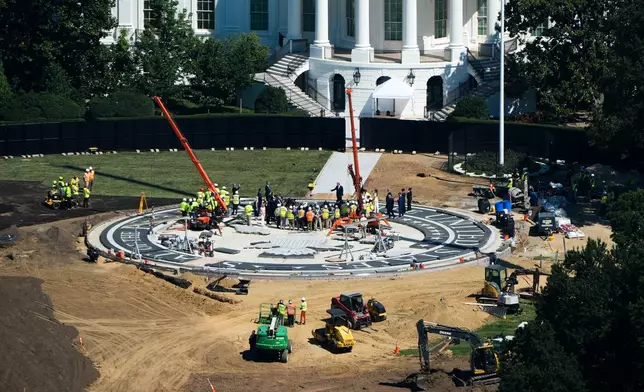 President Donald Trump speaks on the South Lawn of the White House at the construction site of the new helicopter landing zone, Wednesday, Aug. 19, 2026, seen from the Washington Monument in Washington. (AP Photo/Alex Brandon)