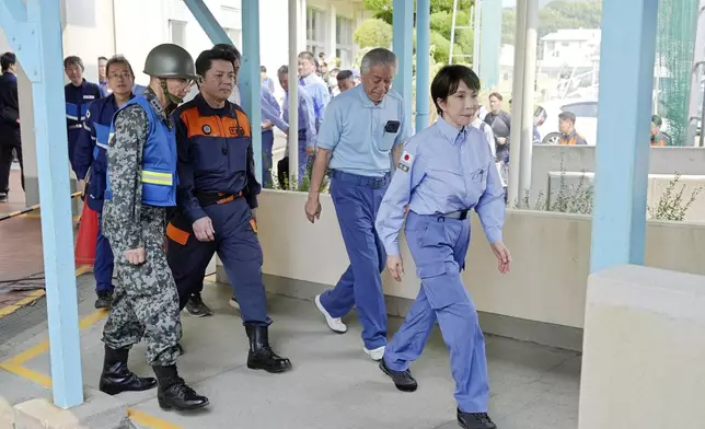 Japan's Prime Minister Sanae Takaichi visits an evacuation center in Hikawa, southern Japan, Monday, Aug. 3, 2026. (Japan Pool/Kyodo News via AP)