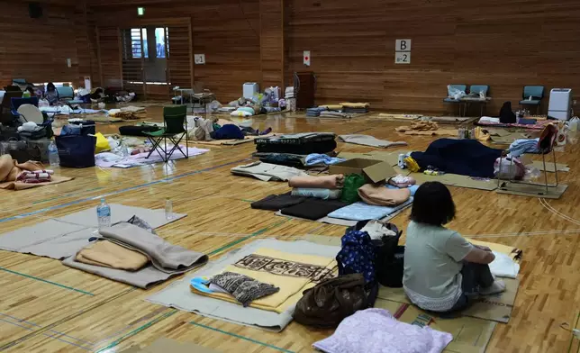 People rest at an evacuation center in Uki, southern Japan, Sunday, Aug. 2, 2026, after recent earthquakes. (Yuta Omori/Kyodo News via AP)