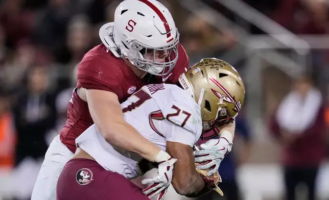 FILE - Stanford linebacker Matt Rose, left, tackles Florida State running back Gavin Sawchuk during the second half of an NCAA college football game, Oct. 18, 2025, in Stanford, Calif. (AP Photo/Godofredo A. Vásquez, File)