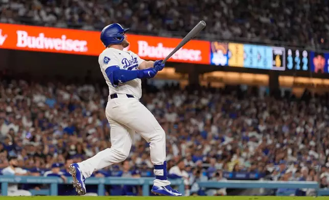 Los Angeles Dodgers' Max Muncy hits a three-run home run during the sixth inning of a baseball game against the Milwaukee Brewers, Thursday, Aug. 13, 2026, in Los Angeles. (AP Photo/Mark J. Terrill)
