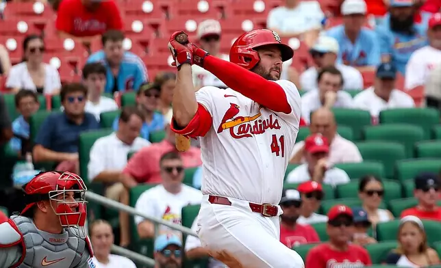 St. Louis Cardinals' Alec Burleson follows through on and RBI single during the seventh inning of a baseball game against the Philadelphia Phillies Wednesday, Aug. 12, 2026, in St. Louis. (AP Photo/Scott Kane)
