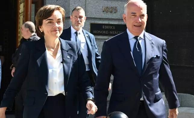 Coalition Avenir Quebec Leader Christine Frechette walks with her spouse Guy Nadeau heading to the Lt. Governor's office to launch a general election in Quebec City, on Thursday, Aug. 27, 2026. (Jacques Boissinot/The Canadian Press via AP)