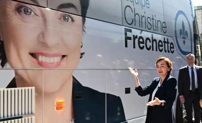 Coalition Avenir Quebec Leader Christine Frechette poses as she walks by her campaign bus after calling a general election in Quebec City, on Thursday, Aug. 27, 2026. (Jacques Boissinot/The Canadian Press via AP)