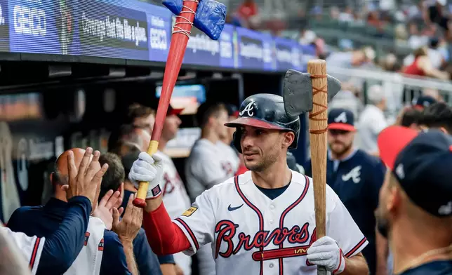 Atlanta Braves' Matt Olson celebrates in the dugout after hitting a solo home run against the Los Angeles Dodgers during the first inning of a baseball game, Wednesday, Aug. 26, 2026, in Atlanta. (AP Photo/Erik S. Lesser)
