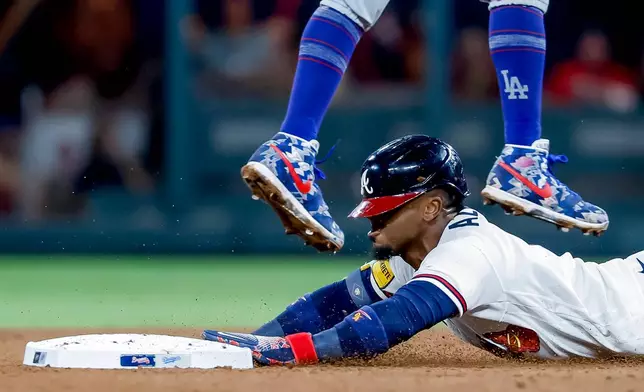 Atlanta Braves Ozzie Albies steals second base against Los Angeles Dodgers shortstop Mookie Betts during the fourth inning of a baseball game, Wednesday, Aug. 26, 2026, in Atlanta. (AP Photo/Erik S. Lesser)