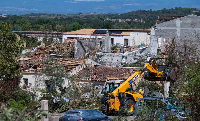 Damaged houses are pictured after a tornado ravaged the small village of Pomas in southern France, leaving dozens injured, Tuesday Aug. 25, 2026. (AP Photo/Frederic Lancelot)