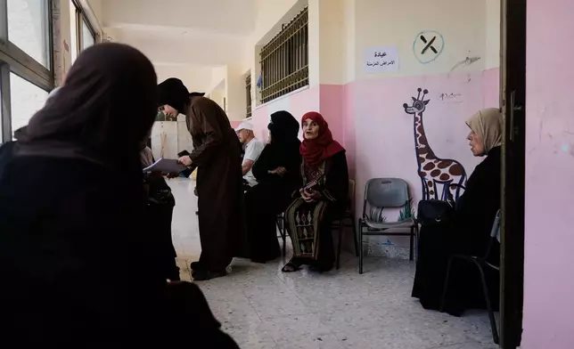 Palestinian patients wait for treatment at a mobile clinic operated by Physicians for Human Rights Israel (PHRI) in the West Bank town of Iktaba, Tuesday, Aug. 4, 2026. (AP Photo/Majdi Mohammed)