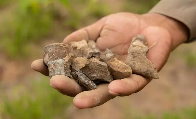 A deminer holds up the remnants of a destroyed anti-personnel landmine in Siem Reap, Cambodia on Thursday, July 2, 2026. (AP Photo/Anton L. Delgado)