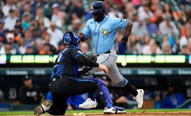 Tampa Bay Rays' Jorge Mateo, right, scores as Detroit Tigers catcher Dillon Dingler, left, waits for the throw during the fourth inning of a baseball game Monday, Aug. 24, 2026, in Detroit. (AP Photo/Paul Sancya)