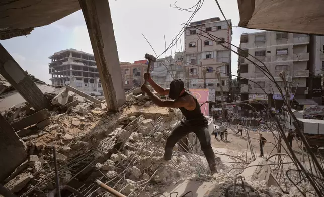 Palestinians remove iron from the rubble of buildings destroyed by Israeli airstrikes during the war with Hamas, repair and recycle it for construction, building tents or selling it, in Gaza City, Sunday, Aug. 16, 2026. (AP Photo/Jehad Alshrafi)