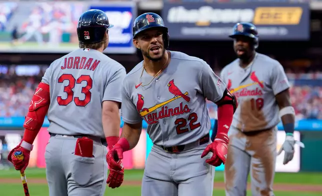 St. Louis Cardinals' Joshua Baez, center, celebrates after his two-run home run with Blaze Jordan, left, during the first inning of a baseball game against the Philadelphia Phillies, Friday, Aug. 21, 2026, in Philadelphia. (AP Photo/Chris Szagola)