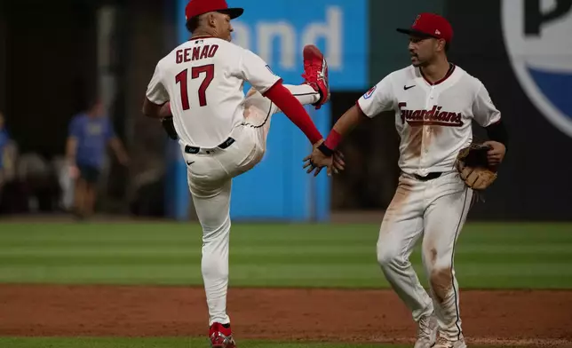 Cleveland Guardians' Angel Genao (17) greets Steven Kwan, right, at the end of a baseball game against the San Diego Padres, Saturday, Aug. 15, 2026, in Cleveland. (AP Photo/Phil Long)