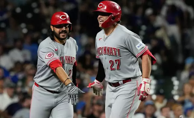 Cincinnati Reds' Sal Stewart, right, celebrates with Eugenio Suárez after hitting a solo home run during the seventh inning of a baseball game against the Chicago Cubs in Chicago, Sunday, Aug. 30, 2026. (AP Photo/Nam Y. Huh)