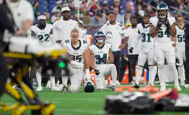 Philadelphia Eagles players watch after teammate Ja'Quinden Jackson was injured against the New England Patriots during the first half of an NFL preseason football game, Saturday, Aug. 22, 2026, in Foxborough, Mass. (AP Photo/Robert F. Bukaty)
