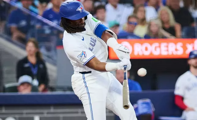 Toronto Blue Jays' Charles McAdoo hits a home run against the Boston Red Sox during the fifth inning of a baseball game in Toronto, Monday, Aug. 10, 2026. (Sammy Kogan/The Canadian Press via AP)