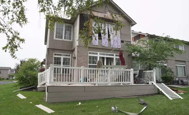 A home is damaged after a storm in Tinley Park, Ill., Tuesday, Aug. 11, 2026. (AP Photo/Laura Bargfeld)