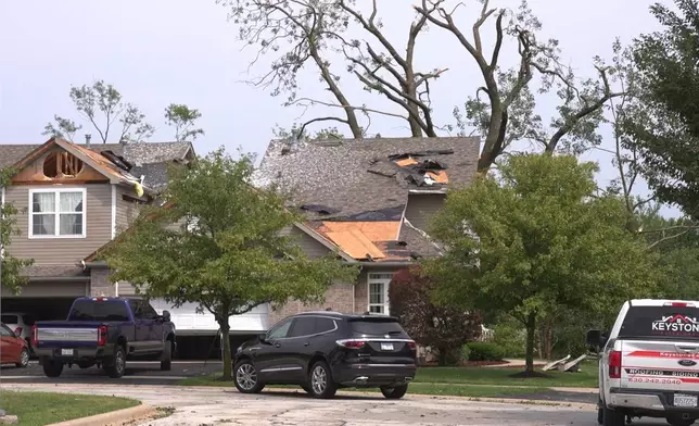 In this image made from video, a roof is damaged after a strong storm in Tinley Park, Ill., Tuesday, Aug. 11, 2026. (AP Photo/Laura Bargfeld)