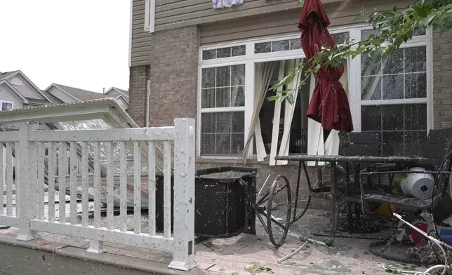In this image made from video, damage caused by a strong storm is seen a home in Tinley Park, Ill., Tuesday, Aug. 11, 2026. (AP Photo/Laura Bargfeld)