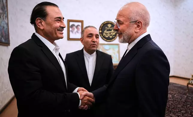 In this photo released by Islamic Consultative Assembly News Agency, ICANA, Iran's Parliament Speaker and top negotiator Mohammad Bagher Qalibaf, right, shakes hands with Pakistan's Army Chief Field Marshal Gen. Asim Munir during their meeting in Tehran, Iran, Monday, Aug. 24, 2026. (Mahmoud Hosseini/ICANA via AP)