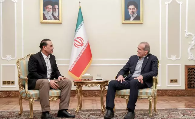 In this photo released by the Iranian Presidency Office, President Masoud Pezeshkian, right, meets Pakistan's Army Chief Field Marshal Gen. Asim Munir in Tehran, Iran, Monday, Aug. 24, 2026. (Iranian Presidency Office via AP)