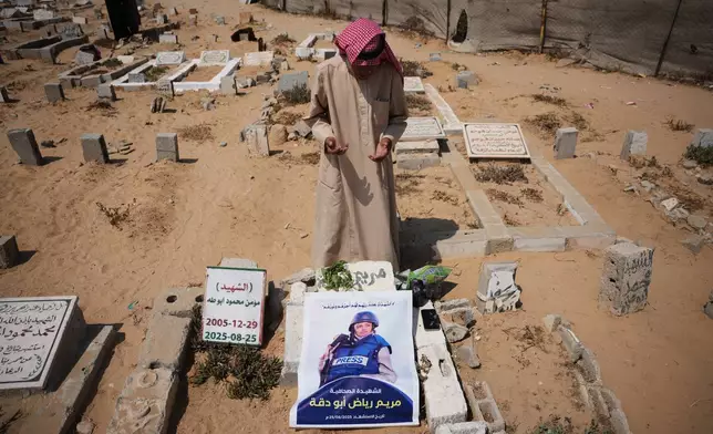Riyad Abu Dagga, 69, visits the grave of his daughter, Mariam Dagga, a freelance journalist who worked with The Associated Press and other news outlets during the Gaza war and was killed in an Israeli airstrike on the Nasser Hospital building in Khan Younis on Aug. 25, 2025, at a cemetery in Khan Younis, Gaza Strip, Aug. 16, 2026. (AP Photo/Abdel Kareem Hana)