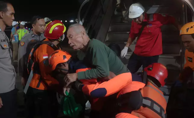 Rescuers assist a survivors of a ferry fire upon arrival at Tanjung Perak Port in Surabaya, East Java, Indonesia, Monday, Aug. 3, 2026. (AP Photo/Trisnadi)