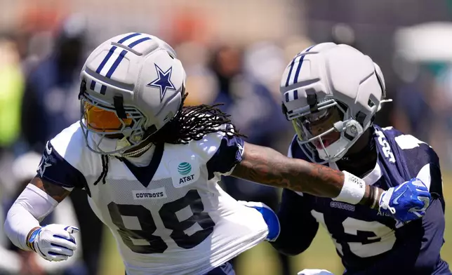 Dallas Cowboys wide receiver Ceedee Lamb, left, breaks away from defensive back Caleb Downs during the NFL football team's training camp, Saturday, Aug. 1, 2026, in Oxnard, Calif. (AP Photo/Mark J. Terrill)