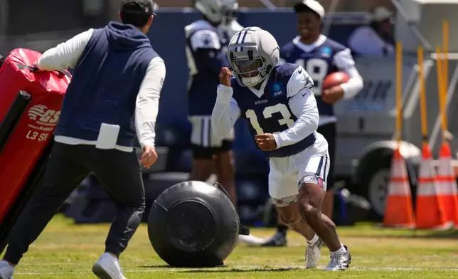Dallas Cowboys defensive back Caleb Downs, right, runs a drill during the NFL football team's training camp, Tuesday, Aug. 4, 2026, in Oxnard, Calif. (AP Photo/Mark J. Terrill)