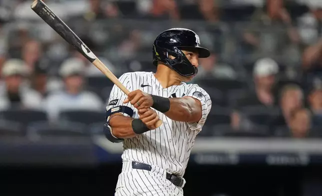 New York Yankees' Trent Grisham hits a two-run home run during the eighth inning of a baseball game against the Seattle Mariners Wednesday, Aug. 12, 2026, in New York. (AP Photo/Frank Franklin II)