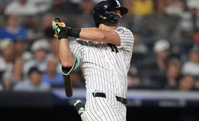 New York Yankees' Spencer Jones hits an RBI double during the fifth inning of a baseball game against the Seattle Mariners Wednesday, Aug. 12, 2026, in New York. (AP Photo/Frank Franklin II)