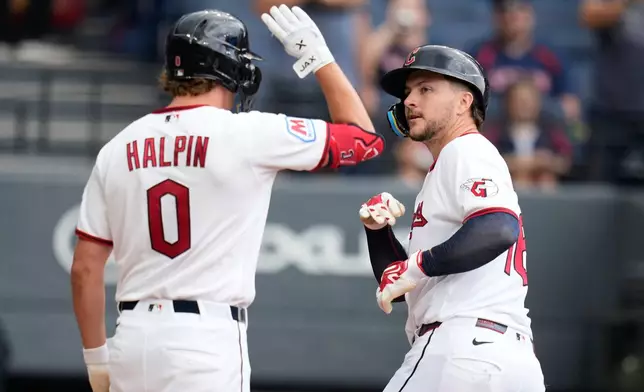 Cleveland Guardians' Patrick Bailey, right, celebrates with Petey Halpin (0) after hitting a home run in the third inning of a baseball game against the Arizona Diamondbacks in Cleveland, Sunday, Aug. 2, 2026. (AP Photo/Sue Ogrocki)