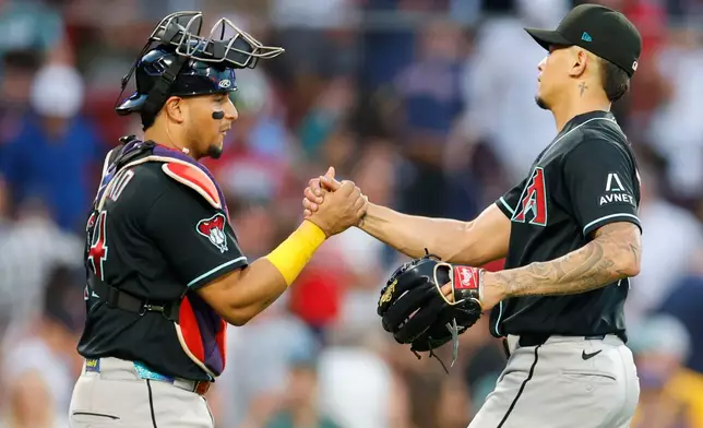 Arizona Diamondbacks catcher Gabriel Moreno congratulates pitcher' Jonathan Loáisiga following the win of a baseball game over the Boston Red Sox Wednesday, Aug. 19, 2026, in Boston. (AP Photo/CJ Gunther)