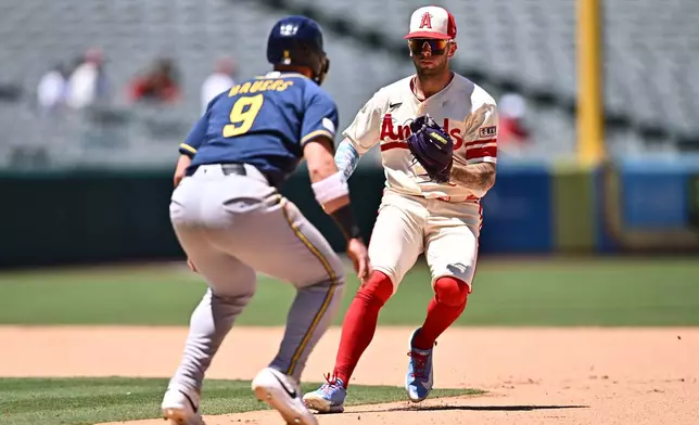Los Angeles Angels shortstop Zach Neto, right, runs down Milwaukee Brewers' Jake Bauers (9) during the seventh inning of a baseball game Sunday, Aug. 2, 2026, in Anaheim, Calif. (AP Photo/William Liang)