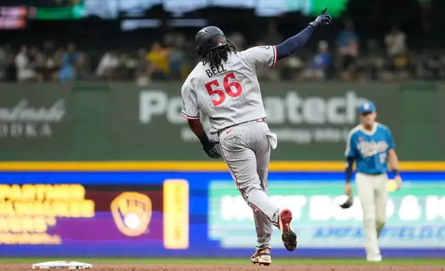 Minnesota Twins' Josh Bell gestures as he rounds the bases after hitting a two-run home run during the third inning of a baseball game against the Milwaukee Brewers, Friday, Aug. 7, 2026, in Milwaukee. (AP Photo/Aaron Gash)
