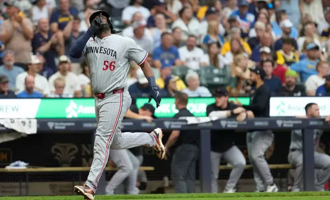 Minnesota Twins' Josh Bell gestures as he rounds the bases after hitting a two-run home run during the third inning of a baseball game against the Milwaukee Brewers, Friday, Aug. 7, 2026, in Milwaukee. (AP Photo/Aaron Gash)