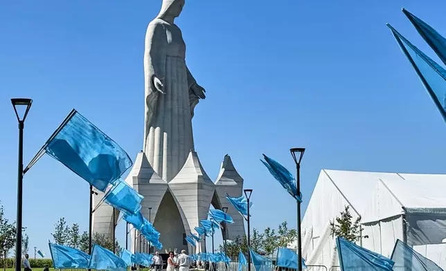 People walk inside an enormous statue of the Virgin Mary that is believed to be Europe's tallest during the inauguration in the village Konotopie, Poland, Saturday, Aug. 15, 2026. (AP Photo/Claudia Ciobanu)