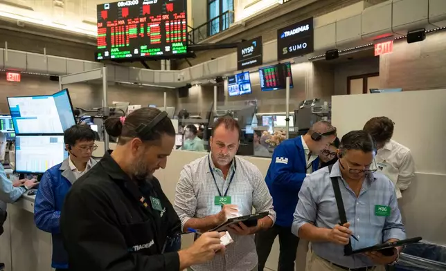 Options traders Chris Dattolo, Scott Frinzi, and Ravi Bhandari, left to right, work on the floor of the New York Stock Exchange, Monday, Aug. 17, 2026, in New York. (AP Photo/Yuki Iwamura)