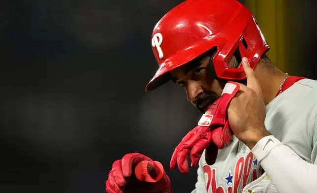 Philadelphia Phillies' Derek Hill gestures after reaching first on an RBI but during the fifth inning of a baseball game against the Los Angeles Angels, Friday, Aug. 28, 2026, in Anaheim, Calif. (AP Photo/Mark J. Terrill)