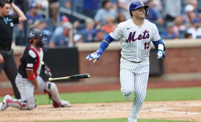 New York Mets' Luis Torrens (13) watches his home run during the fourth inning of a baseball game against the Washington Nationals, Sunday, Aug. 16, 2026, in New York. (AP Photo/Heather Khalifa)
