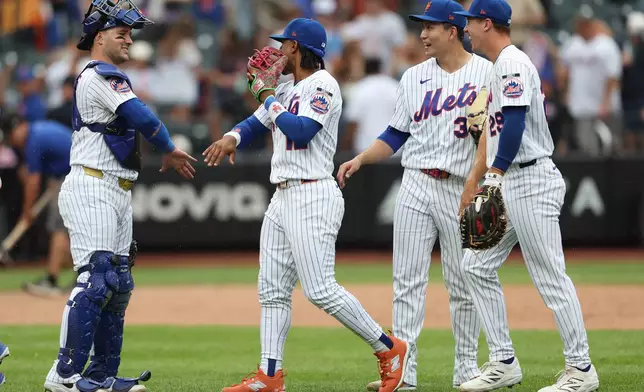 New York Mets catcher Luis Torrens and shortstop Francisco Lindor celebrate after a win over the Washington Nationals in the ninth inning of a baseball game, Sunday, Aug. 16, 2026, in New York. (AP Photo/Heather Khalifa)